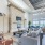 Large well lit clubhouse with ample seating large windows and a fire place 