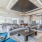 Large well lit clubhouse with ample seating large windows and a fire place 