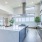 Spacious community kitchen with large bar seating and stainless steel appliances 