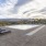 Large sparkling blue pool with a large pool deck and lounge chairs