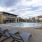 Large sparkling blue pool with a large pool deck and lounge chairs