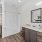 Large well lit bathroom with white accents 