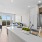 Spacious and well lit kitchen with wood flooring and stainless steel appliances