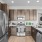 Spacious and well lit kitchen with wood flooring and stainless steel appliances