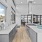 Large demonstration kitchen with large windows and wood floors 