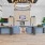 Spacious and well lit lobby with wood floors and a large fireplace 