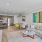 Spacious and well lit living room with wood flooring, large windows and open access to the kitchen