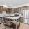 Spacious and well lit kitchen with wood flooring and stainless steel appliances